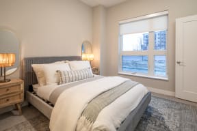 a bedroom with a large bed and a window