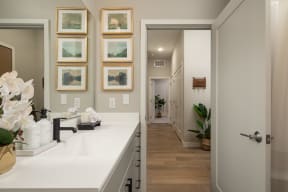 a bathroom with a sink and a door to a hallway