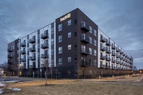 a large apartment building with a sky background