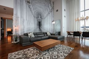 A living room with a grey couch and a wooden coffee table.