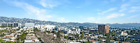 A cityscape with a mountain in the background.