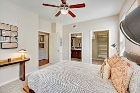 a bedroom with a large bed and a ceiling fan
