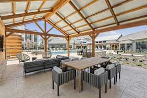 outdoor covered cabana with outdoor dining and lounge area
