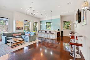 the living room is open to the kitchen and dining room