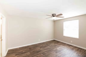 One Bedroom Apartments in Murfreesboro TN - Condos at the Villager - Bedroom with Wood-Style Flooring