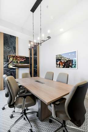 a conference room with a wooden table and chairs