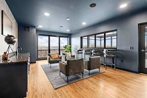 A modern rooftop lounge with a dining area and a view of the outdoors.