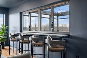 A bar area with four chairs and a counter.