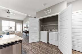 Luxury Apartments in Shawnee, KS with In-Unit Washer and Dryer - Bonavia Luxury Apartments - Laundry Closet with Storage Shelf and Full-Size Washer and Dryer.