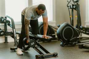 A man is doing push-ups in a gym.