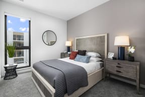 a bedroom with a bed and a large window