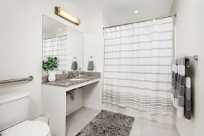 a bathroom with a shower and a sink and a toilet