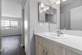 an empty bathroom with a sink and a mirror