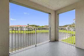 a balcony with a view of a body of water and a fence