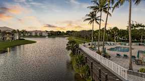 a view of a lagoon with a pool and palm trees
