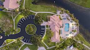 a house shaped like a clock with a pool and a yard