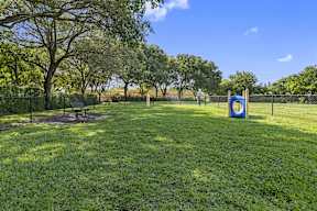 a park with a playground and a target on the grass