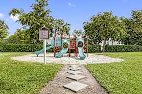 a park with a playground and a sign