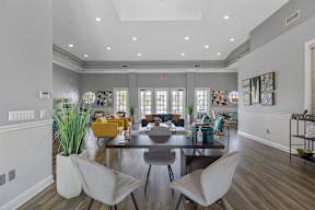 a living room with a large table and chairs