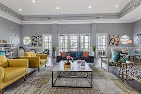 a living room with couches and chairs and a table