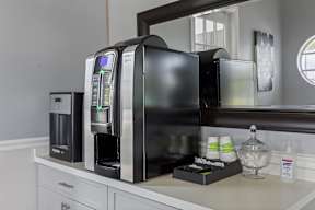 a kitchen with a coffee maker and a microwave on a counter
