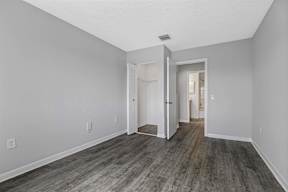 a renovated living room with wood floors and white walls