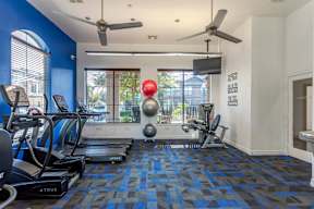 the gym at the district at highland village apartments