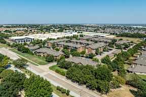 an aerial view of a suburban neighborhood with houses and trees