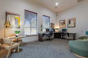 an office with two desks and chairs and a couch