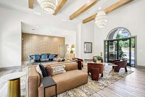 A living room with a brown sofa and a glass door.