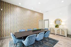 A dining room with a wooden table and blue chairs.