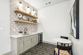 A kitchen with a white counter top and a sink.
