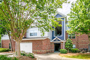 A house with a blue roof and a white garage door.