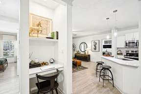 A white room with a desk and a chair.