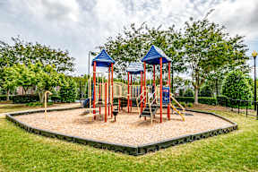 A playground with two towers and a slide.