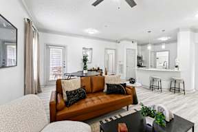 A living room with a brown leather couch and a black coffee table.