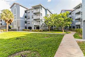 A sunny day at a well-maintained apartment complex with a clear blue sky.
