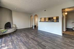 A living room with a fireplace and a wooden floor.