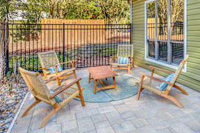 A patio with a table and four chairs.