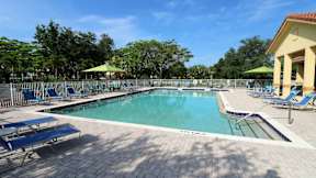 Pool area with lounge seatings and umbrellas