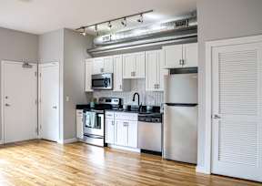 A kitchen with white cabinets and stainless steel appliances.