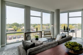 3 BR Apartments in Mount Prospect IL - 20 West - Living Room with Wood-Style Flooring and Floor-to-Ceiling Windows