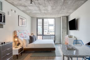 a bedroom with a bed and a tv in a room