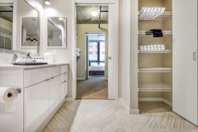 a bathroom with white cabinets and a white sink