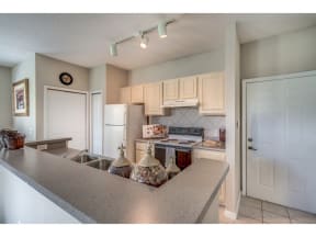 a kitchen with white cabinets and appliances and a counter top