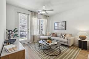a living room with ceiling fan and a couch and a coffee table