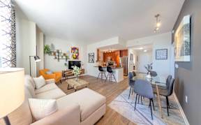 A living room with a white couch and a grey table.