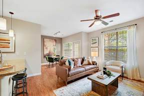 a living room with a couch and a ceiling fan