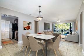 A dining room with a table and chairs.