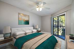 A bedroom with a bed, nightstands, and a painting on the wall.